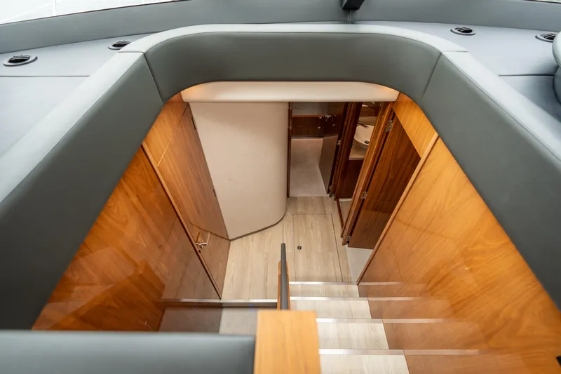 Change Happens Yacht Photos Pics Interior staircase of 2017 Riviera 6000 Sport Yacht with wooden paneling and modern design.