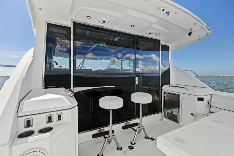 Perfect Match Yacht Photos Pics 2018 Cruisers Yachts 45 Cantius cockpit with bar stools and ocean view.