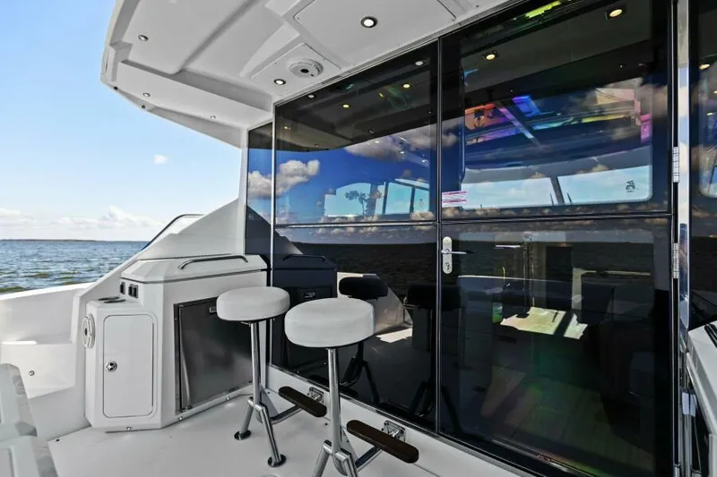 Perfect Match Yacht Photos Pics 2018 Cruisers Yachts 45 Cantius, sleek deck with bar stools and ocean view.