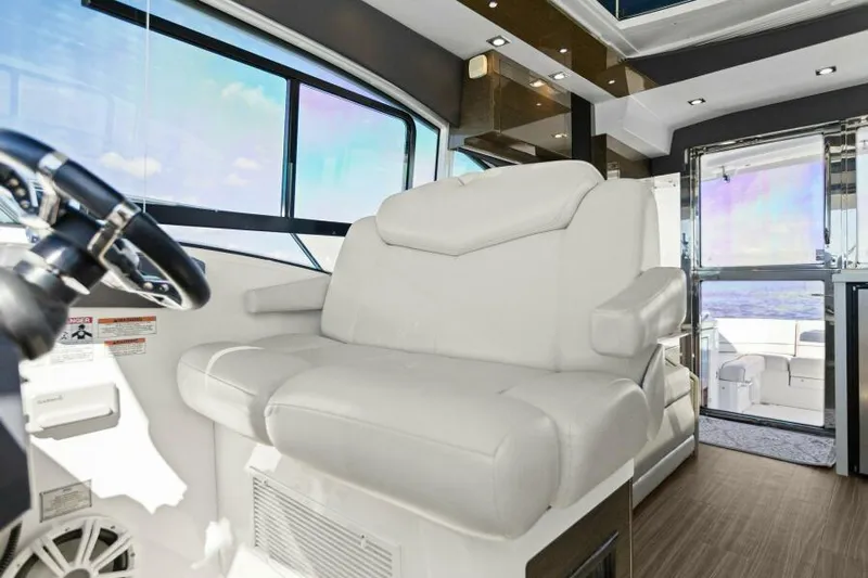 Perfect Match Yacht Photos Pics Luxurious interior of 2018 Cruisers Yachts 45 Cantius with plush white seating.