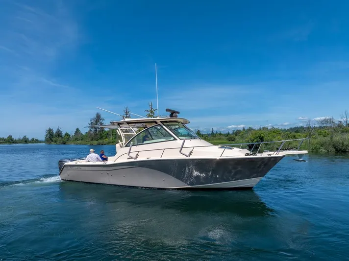  Yacht Photos Pics 2019 Grady-White Express boat cruising on a serene lake under a clear blue sky.