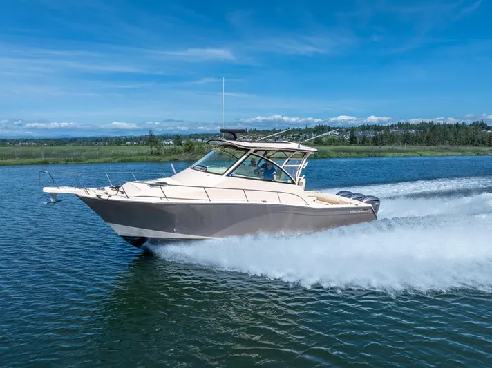  Yacht Photos Pics 2019 Grady-White Express boat cruising on a clear blue lake.