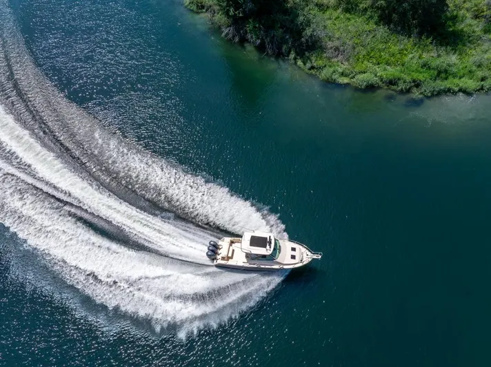  Yacht Photos Pics Aerial view of 2019 Grady-White Express boat cruising on a scenic waterway.