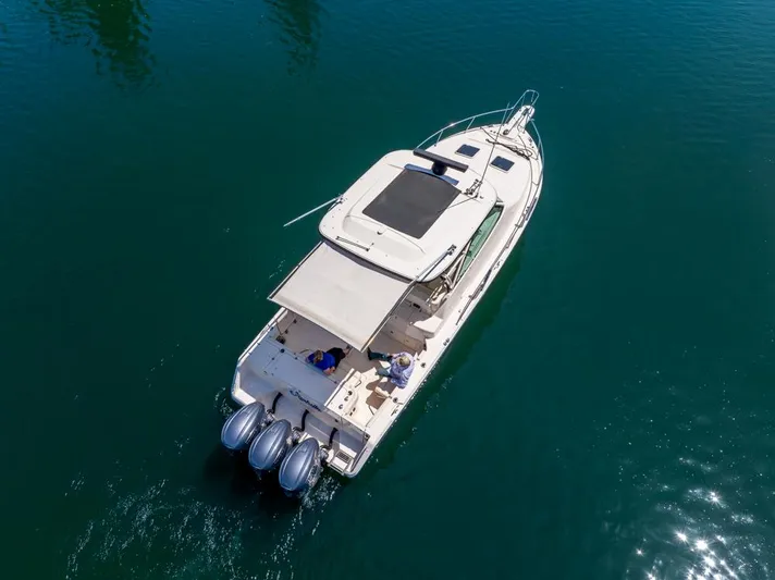  Yacht Photos Pics 2019 Grady-White Express boat on clear blue water, aerial view.