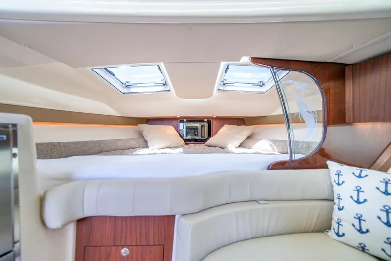  Yacht Photos Pics Luxurious cabin interior of 2019 Grady-White Express boat with skylights and plush bedding.