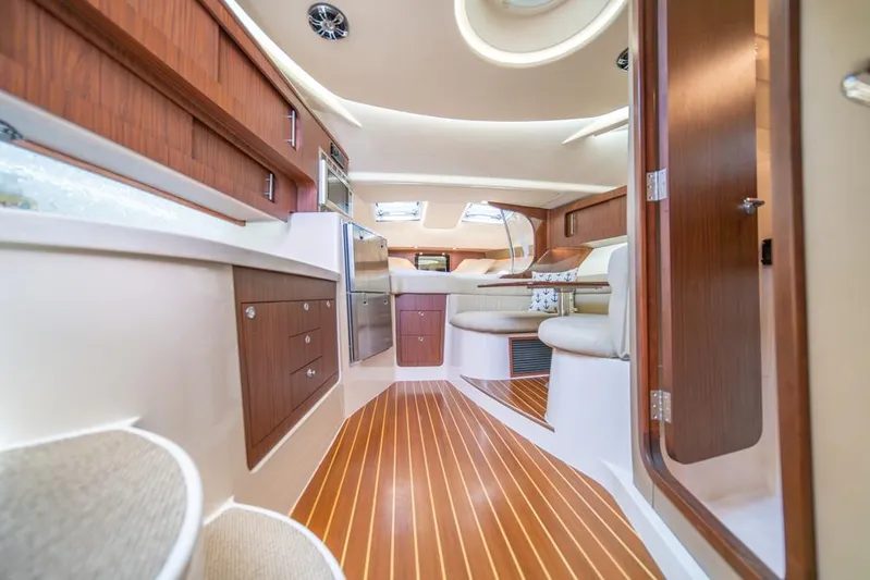  Yacht Photos Pics Luxurious interior of 2019 Grady-White Express boat with wood accents and modern amenities.