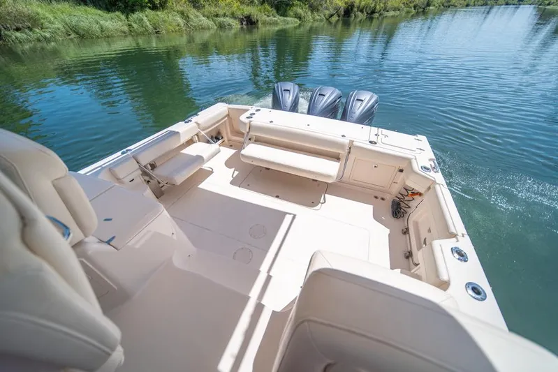  Yacht Photos Pics 2019 Grady-White Express boat interior with seating, on a calm river.