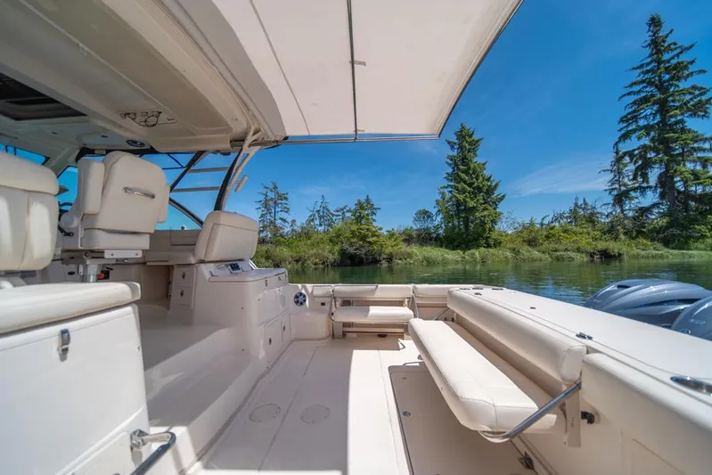  Yacht Photos Pics 2019 Grady-White Express boat interior with seating, canopy, and scenic water view.