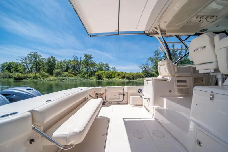  Yacht Photos Pics 2019 Grady-White Express boat interior with seating, under a clear blue sky.