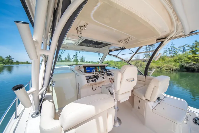  Yacht Photos Pics 2019 Grady-White Express boat interior with helm, white seating, and scenic water view.
