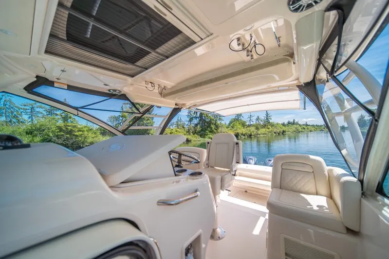  Yacht Photos Pics Interior of 2019 Grady-White Express boat with luxurious seating and scenic water view.