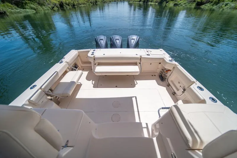  Yacht Photos Pics 2019 Grady-White Express boat interior with seating, on a calm river.