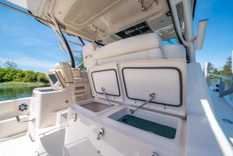 Yacht Photos Pics 2019 Grady-White Express boat interior with open storage compartments, sunny day.