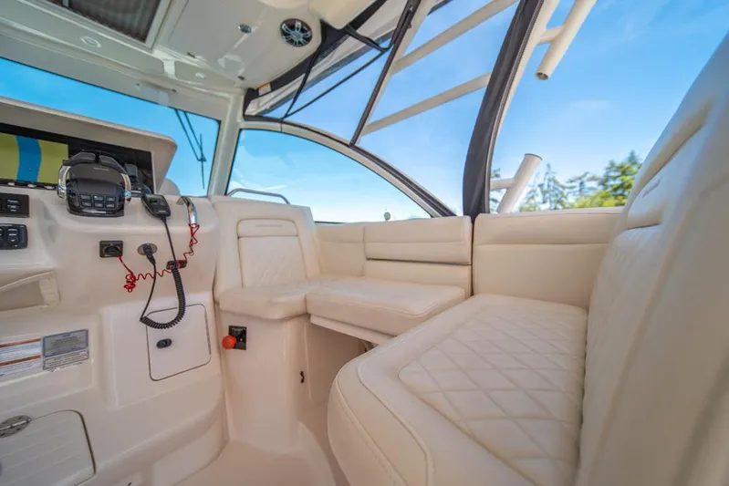  Yacht Photos Pics 2019 Grady-White Express boat interior with plush seating and control panel.