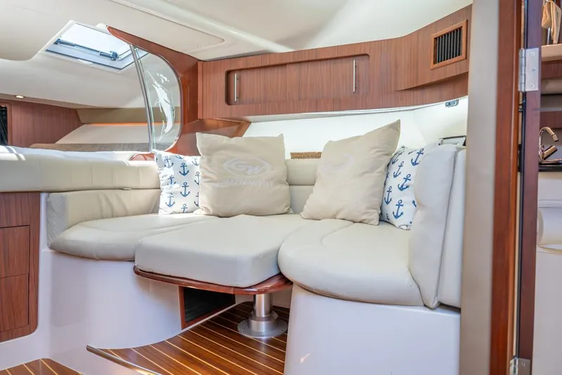  Yacht Photos Pics 2019 Grady-White Express boat interior with plush seating and nautical-themed cushions.
