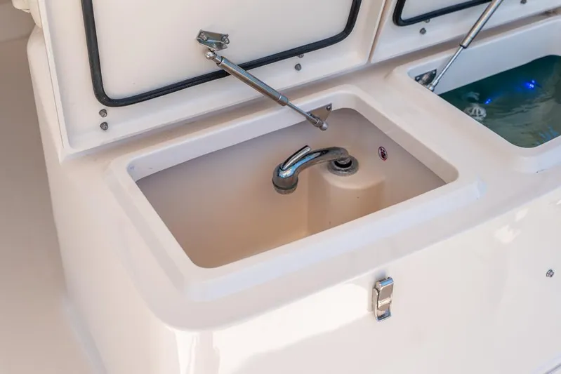  Yacht Photos Pics 2019 Grady-White Express boat sink and storage compartments.