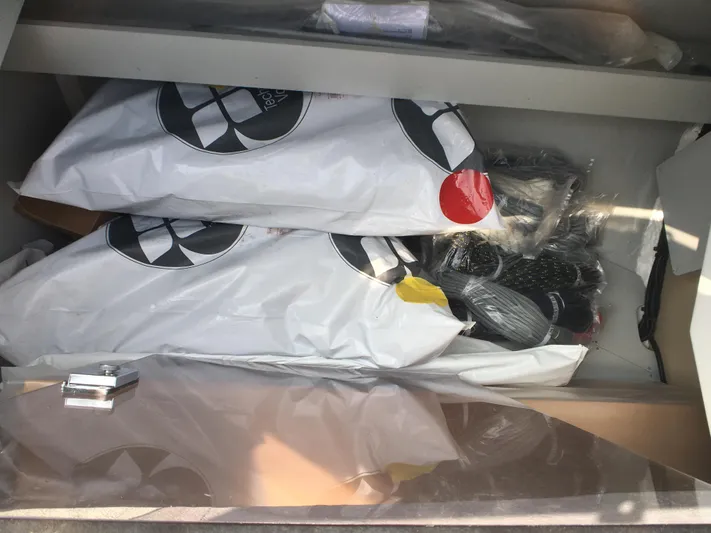  Yacht Photos Pics Storage compartment on a 2024 Beneteau Oceanis 30.1 yacht, containing packaged equipment.