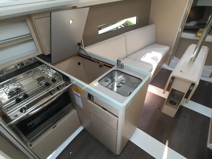  Yacht Photos Pics Interior of 2024 Beneteau Oceanis 30.1 yacht, featuring modern kitchen and seating area.