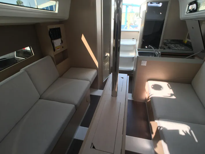  Yacht Photos Pics Interior of 2024 Beneteau Oceanis 30.1 yacht, featuring modern seating and compact kitchen area.