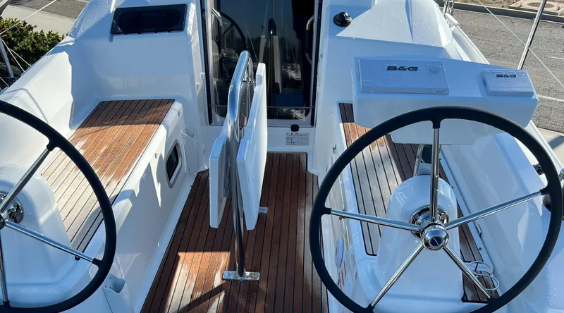  Yacht Photos Pics 2024 Beneteau Oceanis 30.1 yacht cockpit with dual steering wheels and teak flooring.