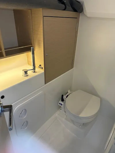  Yacht Photos Pics 2024 Beneteau Oceanis 30.1 yacht bathroom with modern fixtures and compact design.