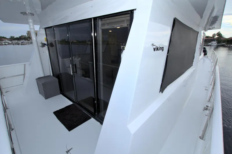 Cleodora Yacht Photos Pics 1988 Viking 63 Cockpit Motor Yacht with sliding glass doors and spacious deck.