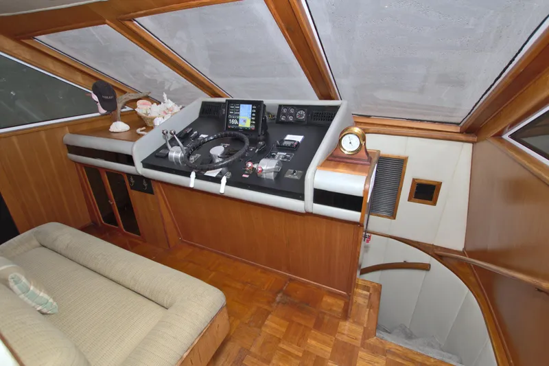 Cleodora Yacht Photos Pics 1988 Viking 63 Cockpit Motor Yacht helm with navigation equipment and wooden interior.