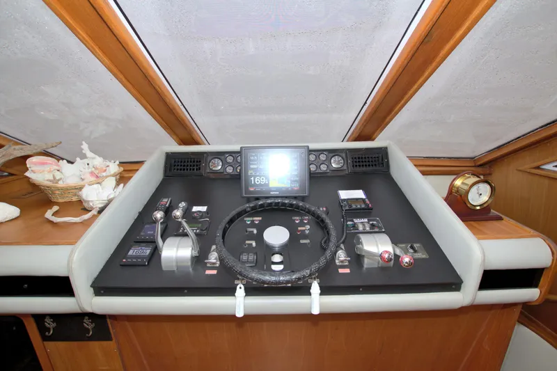Cleodora Yacht Photos Pics 1988 Viking 63 Cockpit Motor Yacht helm with navigation controls and steering wheel.