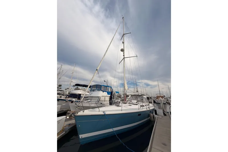 Serendipity II Yacht Photos Pics Sailboat docked at marina, Hunter 460 model, 2002, under cloudy sky.