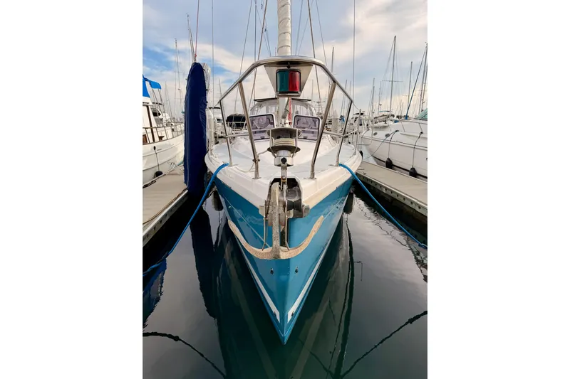 Serendipity II Yacht Photos Pics 2002 Hunter 460 sailboat docked in marina, front view with blue hull.