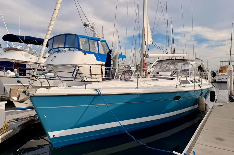 Serendipity II Yacht Photos Pics 2002 Hunter 460 sailboat docked at marina, featuring a sleek blue hull and white deck.