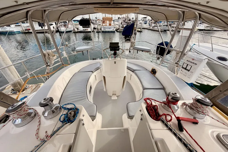 Serendipity II Yacht Photos Pics Cockpit of 2002 Hunter 460 sailboat docked at marina, featuring seating and winches.