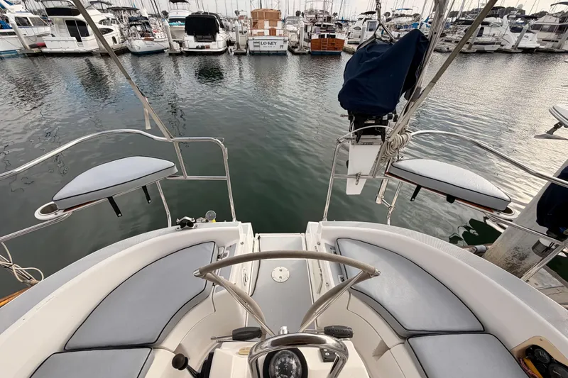 Serendipity II Yacht Photos Pics 2002 Hunter 460 sailboat cockpit view in marina, surrounded by docked boats.
