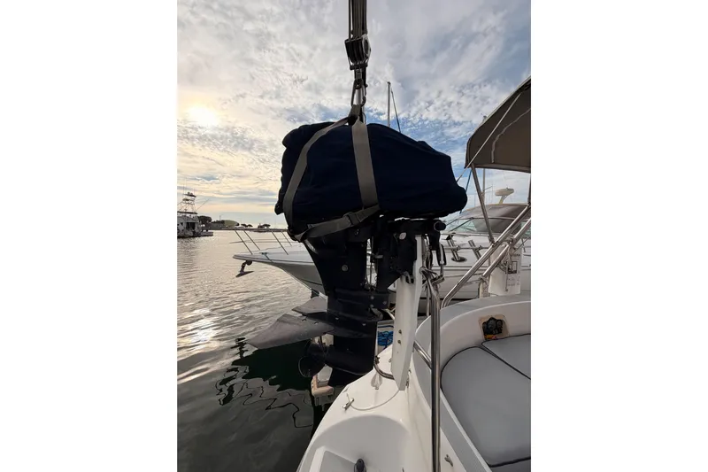 Serendipity II Yacht Photos Pics Hunter 460 sailboat from 2002 with covered outboard motor at marina.