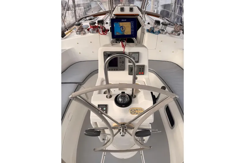 Serendipity II Yacht Photos Pics Cockpit of 2002 Hunter 460 sailboat with navigation equipment and steering wheel.