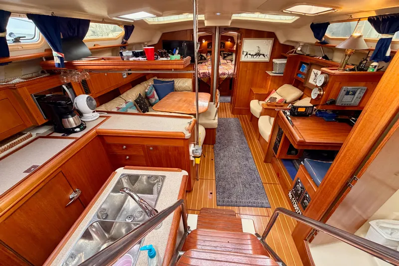 Serendipity II Yacht Photos Pics Luxurious interior of a 2002 Hunter 460 yacht with wood finishes and modern amenities.