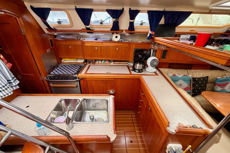 Serendipity II Yacht Photos Pics Cozy 2002 Hunter 460 yacht kitchen with wooden cabinetry and modern appliances.