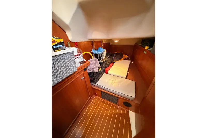 Serendipity II Yacht Photos Pics Cozy cabin interior of 2002 Hunter 460 sailboat with wooden finish and storage.