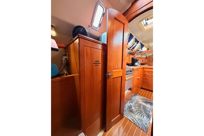 Serendipity II Yacht Photos Pics Interior of 2002 Hunter 460 sailboat with wooden cabinetry and modern kitchen amenities.