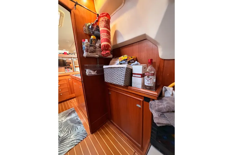 Serendipity II Yacht Photos Pics Interior of 2002 Hunter 460 yacht with wooden cabinets and organized storage.