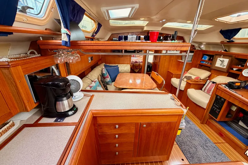 Serendipity II Yacht Photos Pics Luxurious interior of 2002 Hunter 460 yacht with wood finish and cozy seating area.