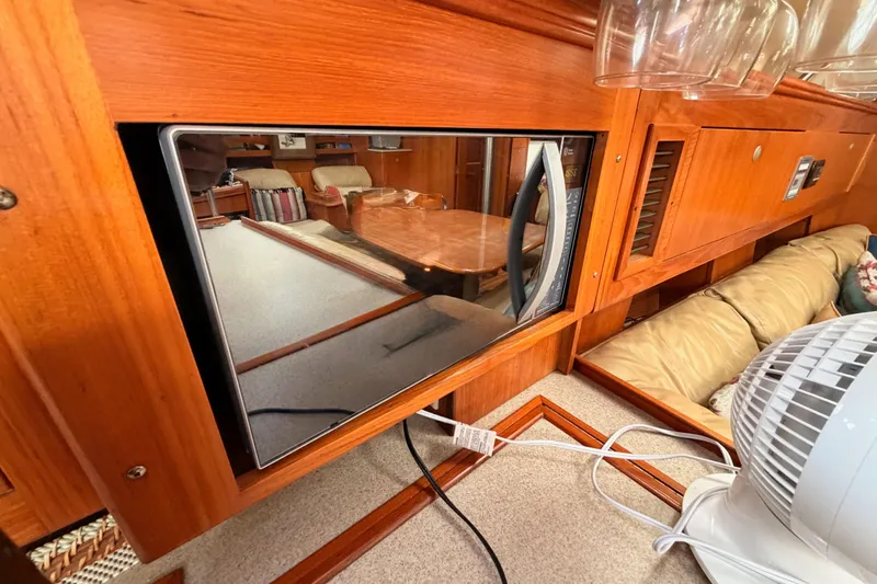 Serendipity II Yacht Photos Pics Interior of a 2002 Hunter 460 yacht with microwave and wooden cabinetry.