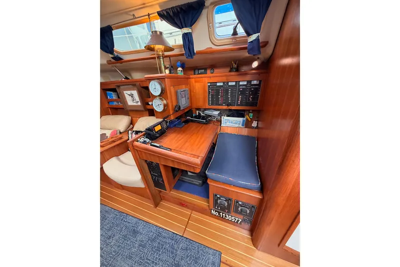 Serendipity II Yacht Photos Pics Interior of 2002 Hunter 460 sailboat with navigation station and wooden finish.