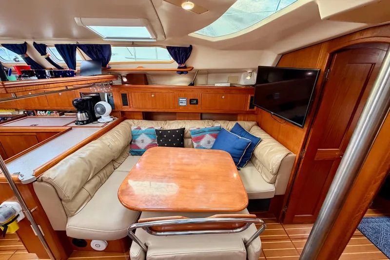 Serendipity II Yacht Photos Pics Cozy interior of 2002 Hunter 460 yacht with dining area and modern amenities.