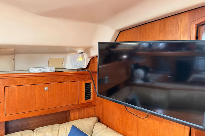 Serendipity II Yacht Photos Pics Interior of 2002 Hunter 460 yacht with TV and wooden cabinetry.