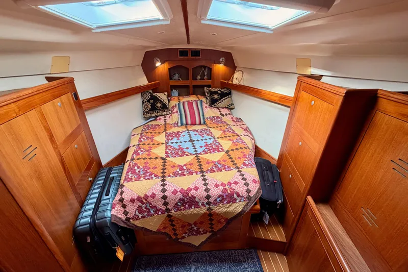 Serendipity II Yacht Photos Pics Cozy cabin interior of 2002 Hunter 460 sailboat with colorful quilted bedspread.
