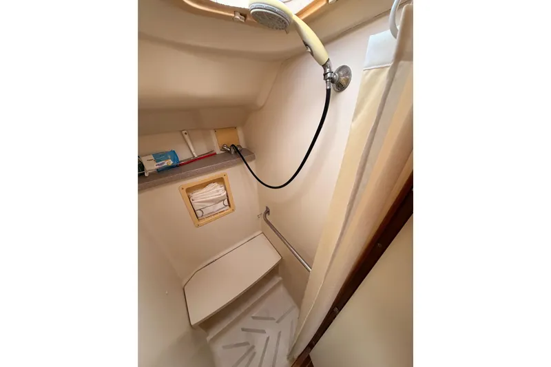 Serendipity II Yacht Photos Pics Compact shower area in a 2002 Hunter 460 sailboat, featuring a handheld showerhead.