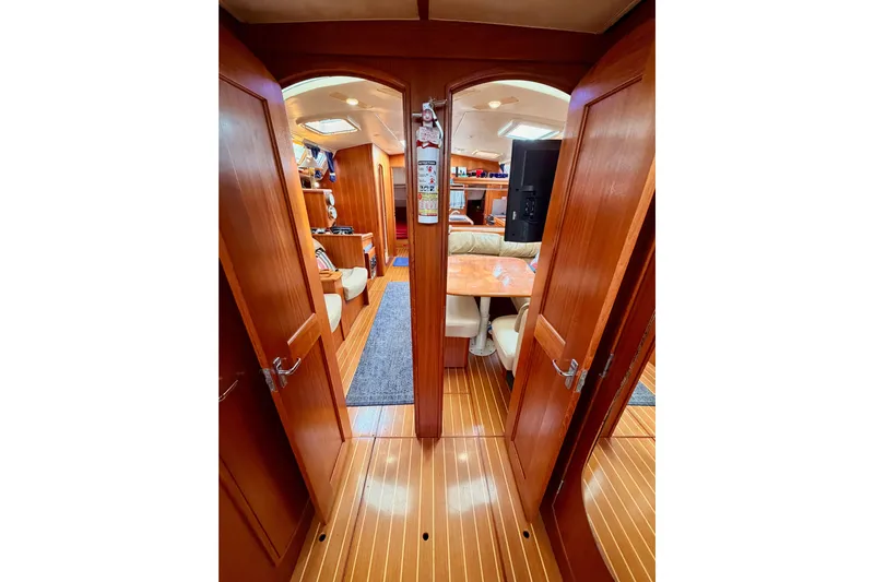 Serendipity II Yacht Photos Pics Interior of 2002 Hunter 460 yacht with wooden finish and cozy seating area.