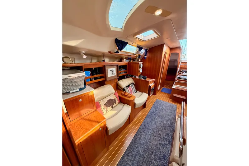 Serendipity II Yacht Photos Pics Interior of 2002 Hunter 460 yacht with cozy seating and wooden cabinetry.