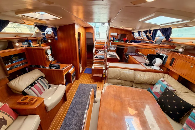 Serendipity II Yacht Photos Pics Luxurious interior of a 2002 Hunter 460 yacht with wood finishes and cozy seating.